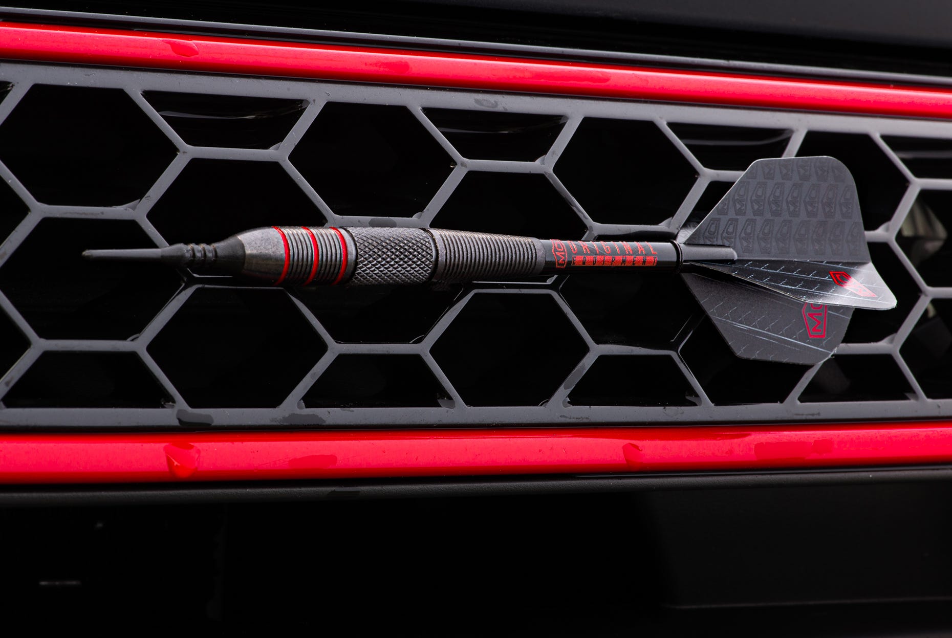 Charger Soft Tip Darts on the grill of the Dodge Charger.